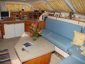 a living room with a couch and a coffee table aboard CATALYST Yacht for Charter