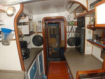 a kitchen with a large open door aboard CATALYST Yacht for Charter