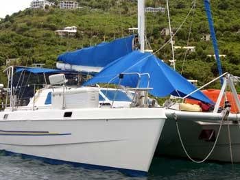 a boat with blue and white tents aboard CATALYST Yacht for Charter