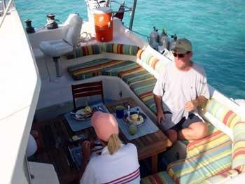 a man and a woman on a boat aboard CATALYST Yacht for Charter