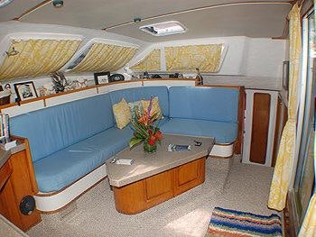 a living room with a couch and a coffee table aboard CATALYST Yacht for Charter