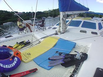 a boat with a surfboard on it aboard CATALYST Yacht for Charter