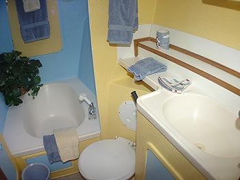 a bathroom with a toilet sink and a bathtub aboard CATALYST Yacht for Charter
