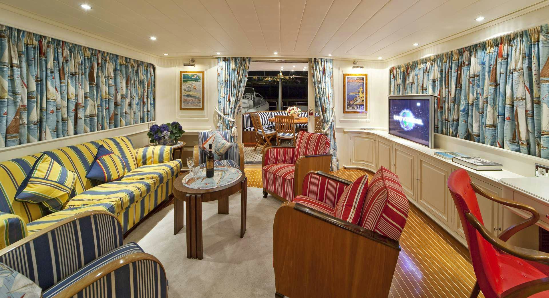 a living room with a couch and a television aboard STAR OF THE SEA Yacht for Charter