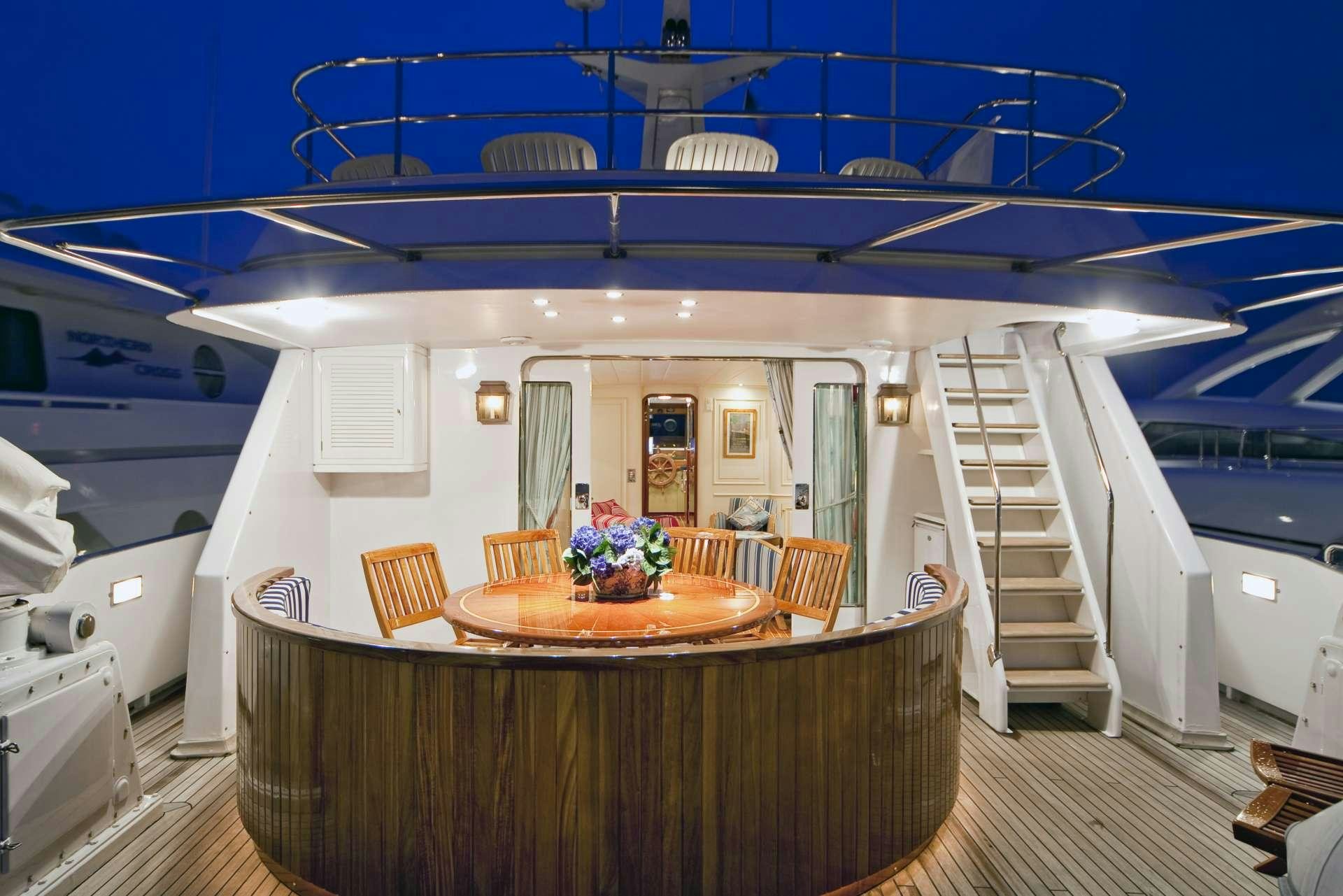 a kitchen with a table and chairs aboard STAR OF THE SEA Yacht for Charter