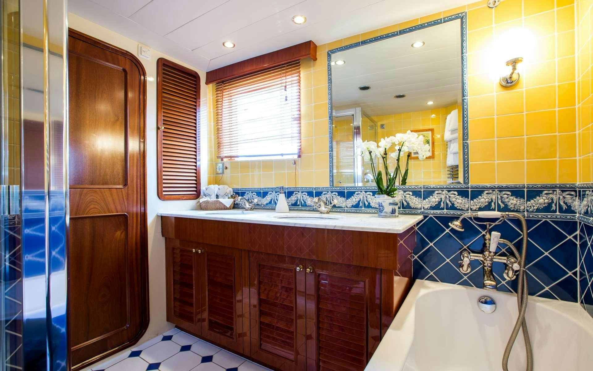a bathroom with a tub sink and cabinets aboard STAR OF THE SEA Yacht for Charter
