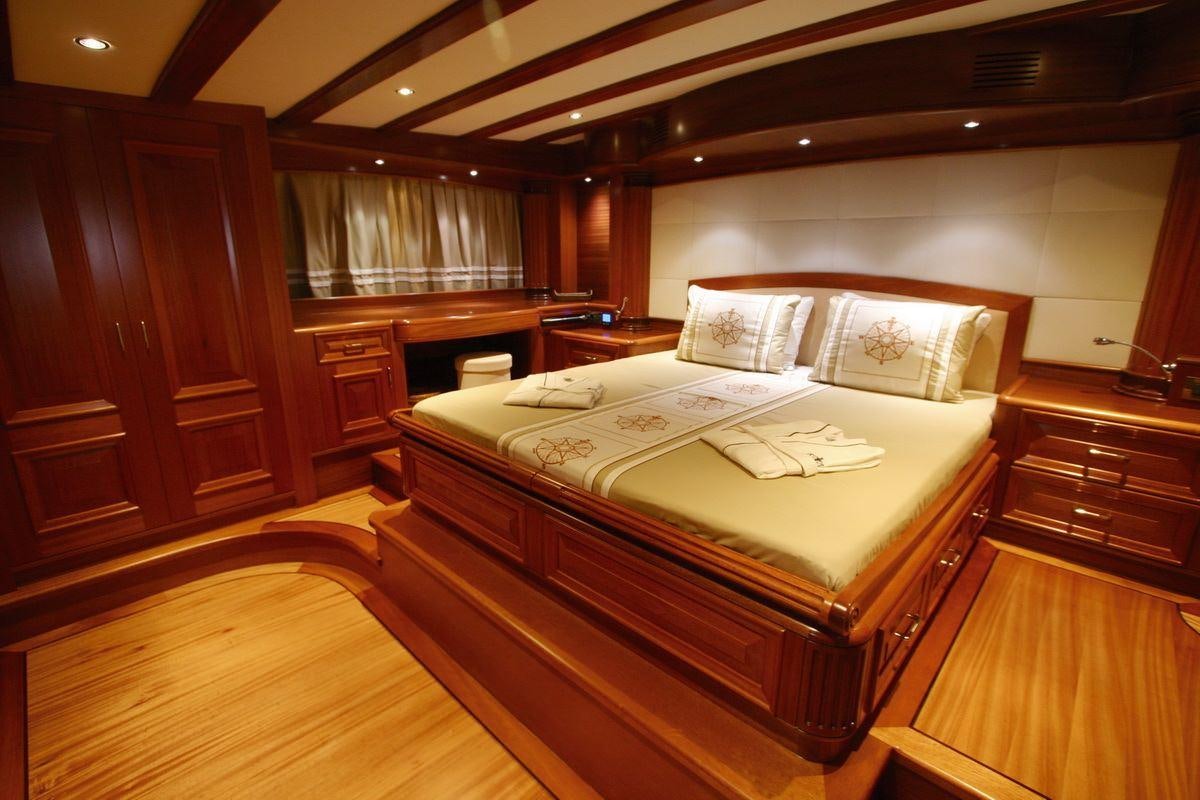 a bed in a room aboard KAYA GUNERI V Yacht for Charter