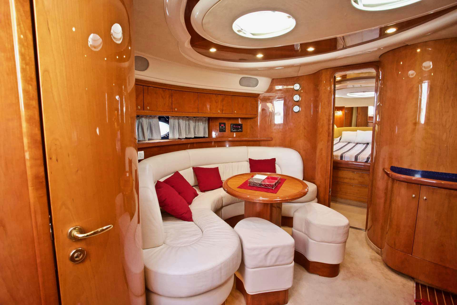 a room with a couch and a table aboard MAGIA Yacht for Charter