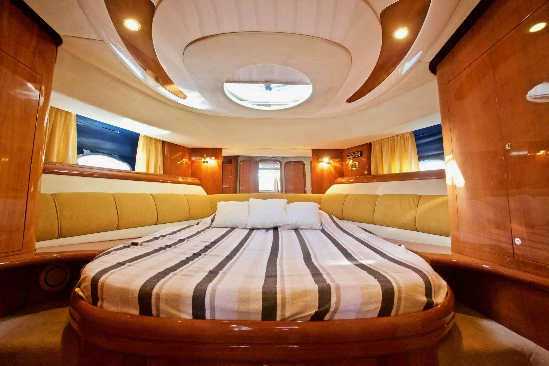 a room with a bed and a window aboard MAGIA Yacht for Charter