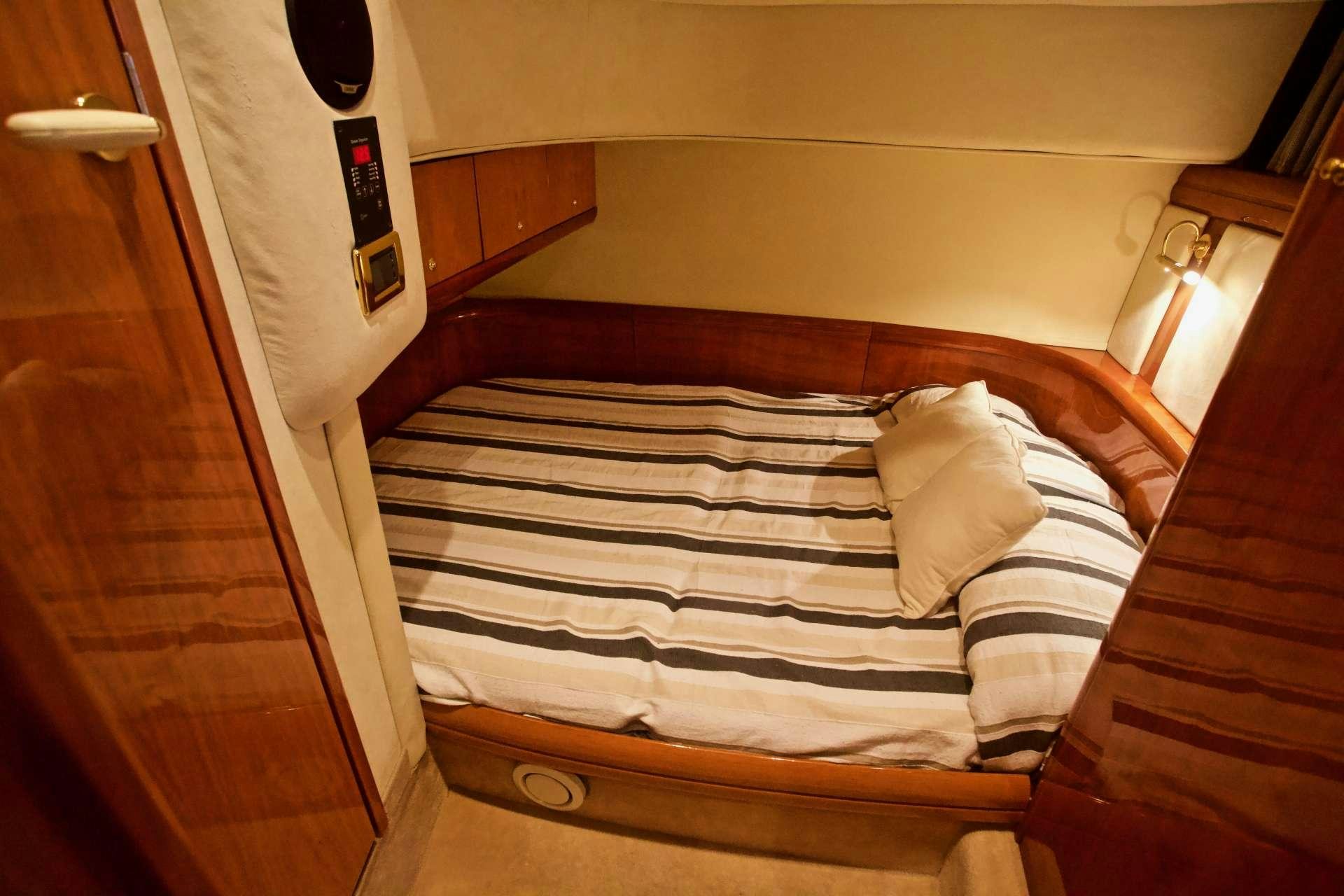 a bed with pillows aboard MAGIA Yacht for Charter