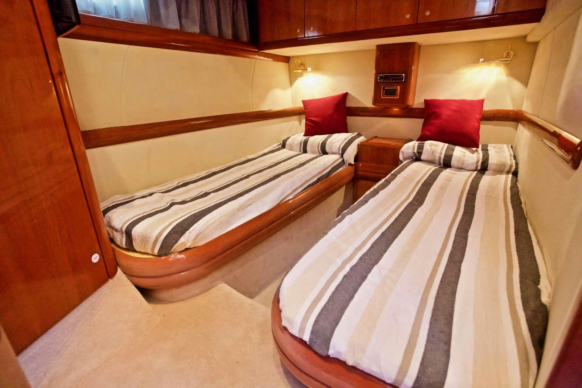 a room with beds and pillows aboard MAGIA Yacht for Charter