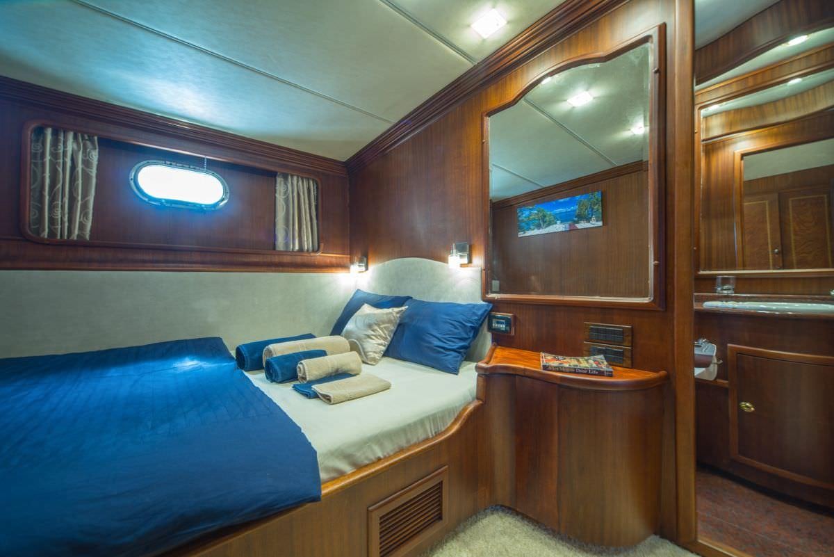a room with a bed and a table aboard ALBA Yacht for Charter