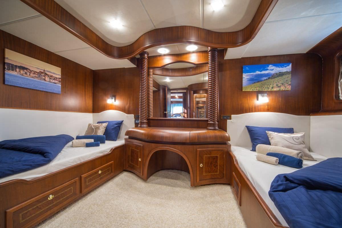 a room with a bed and a piano aboard ALBA Yacht for Charter