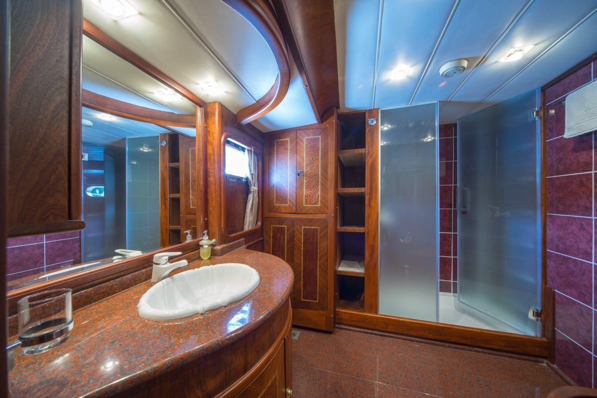 a bathroom with a countertop sink and mirrors aboard ALBA Yacht for Charter