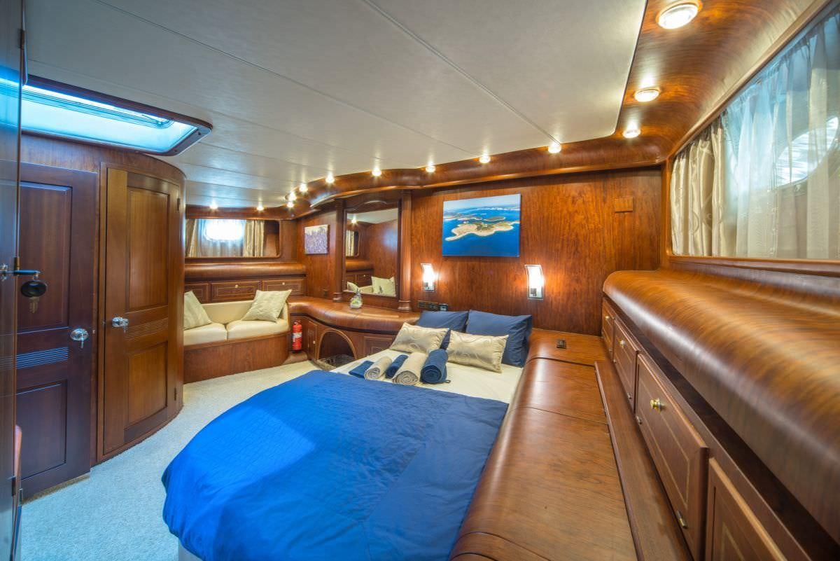 a bedroom with a bed and a couch aboard ALBA Yacht for Charter