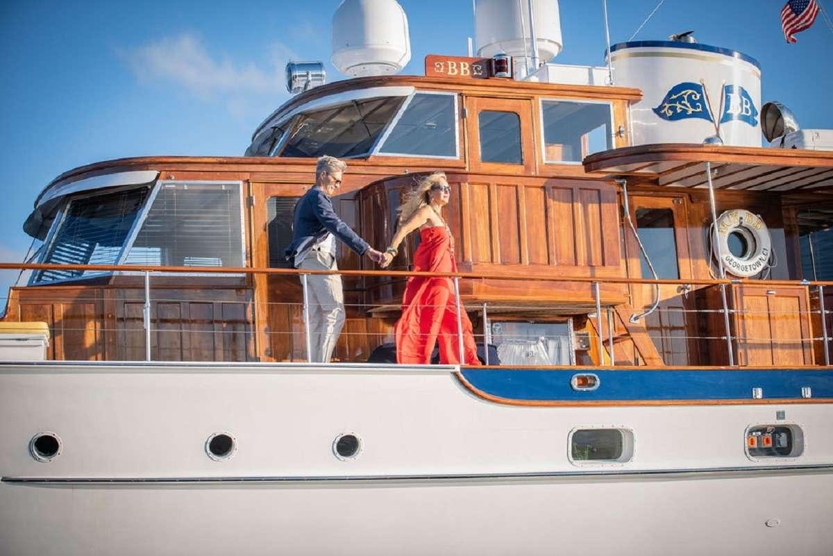 a man and woman standing on a boat aboard BB Yacht for Charter