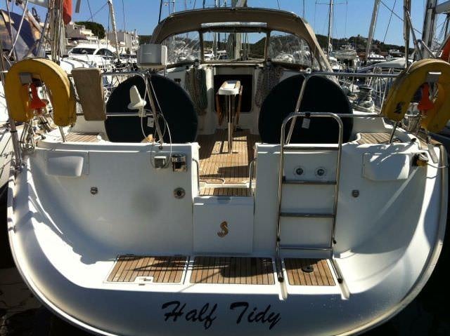 a white boat with black wheels aboard HALF TIDY Yacht for Charter