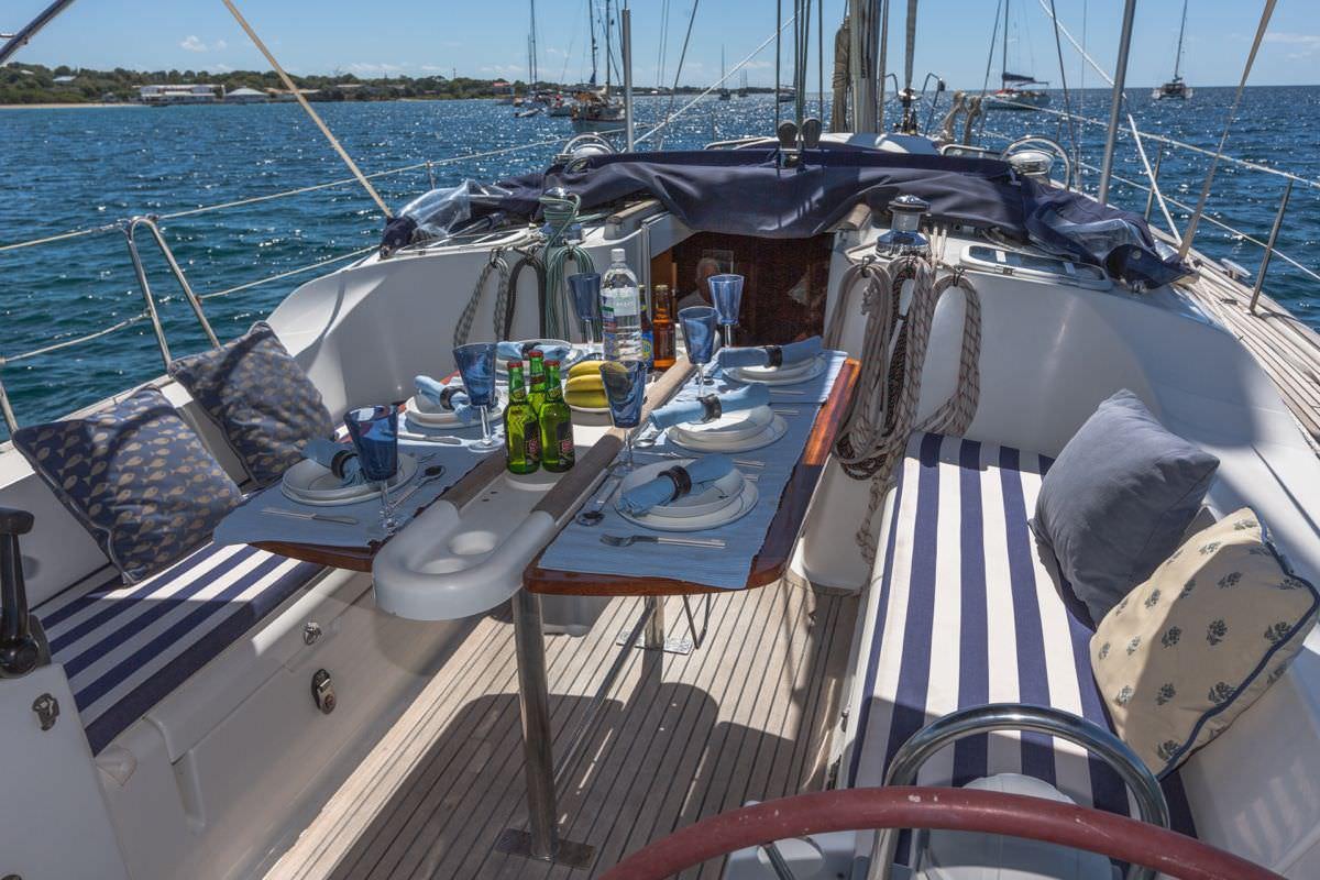 a boat with a table and chairs aboard HALF TIDY Yacht for Charter