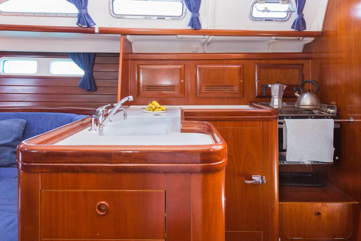 a kitchen with a sink and cabinets aboard HALF TIDY Yacht for Charter