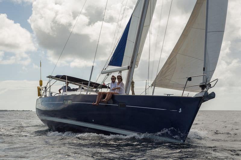 a couple of men on a sailboat aboard HALF TIDY Yacht for Charter