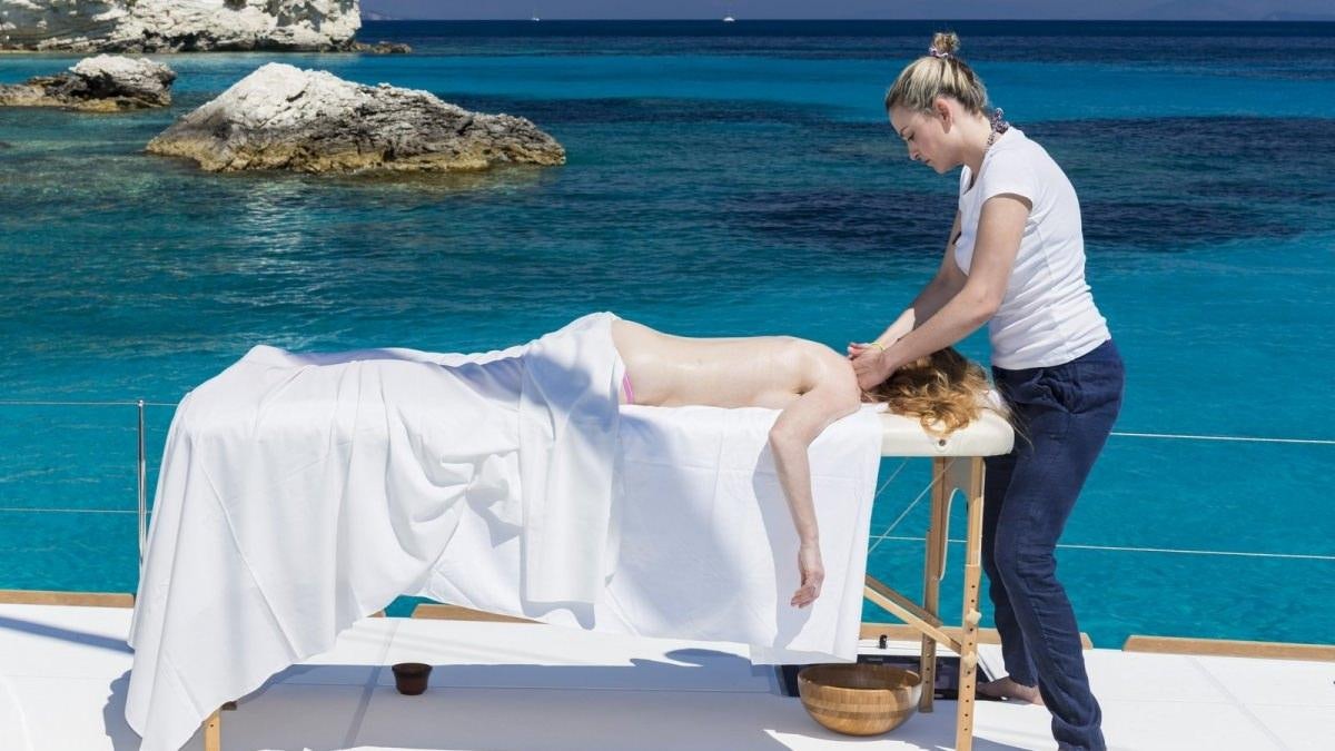 a person holding a baby aboard LAGOON 52 Yacht for Charter