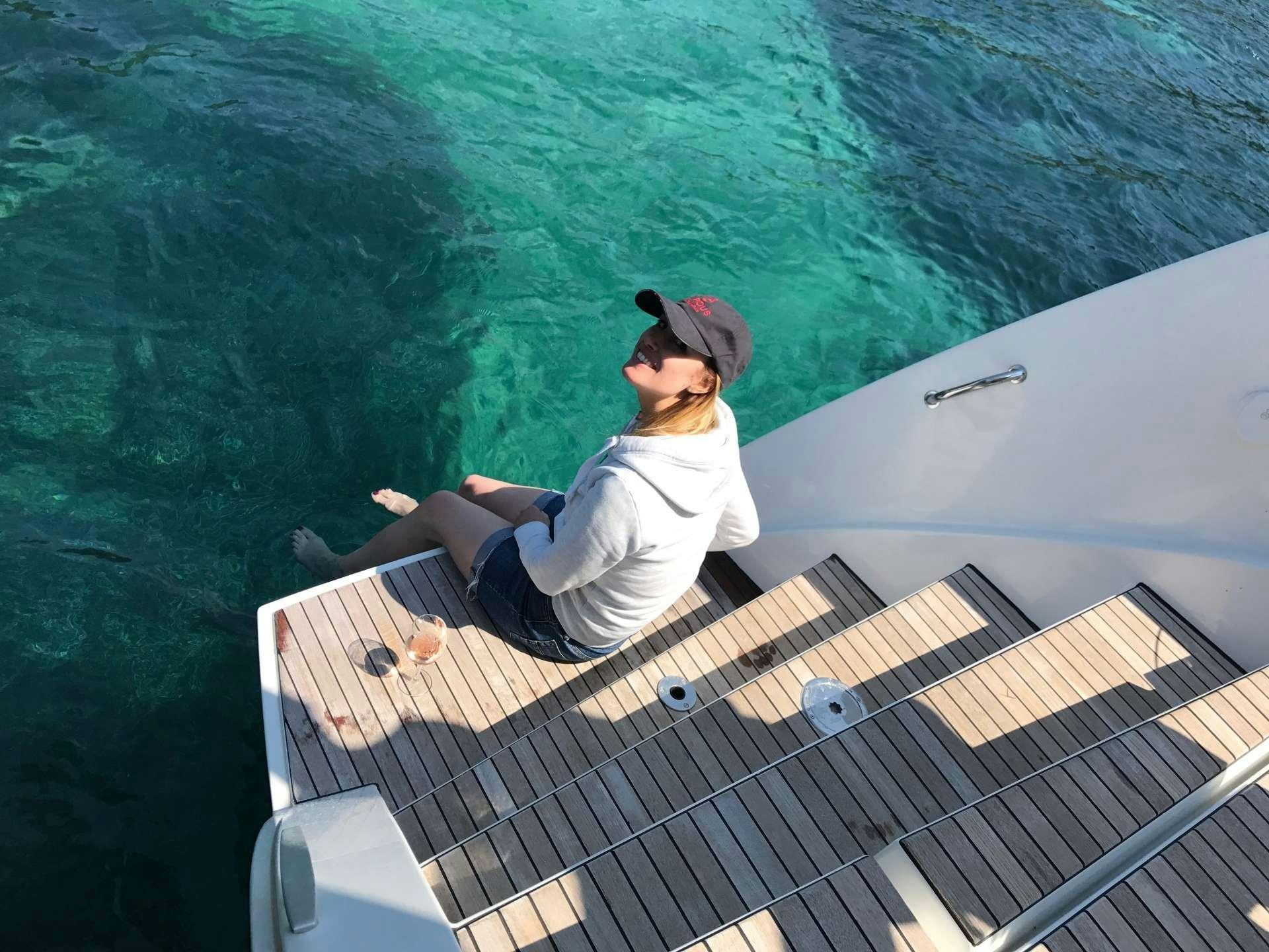 a man sitting on a boat aboard LAGOON 52 Yacht for Charter