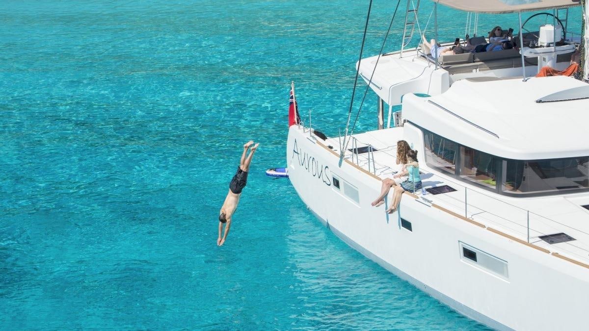 a boat with a person on it aboard LAGOON 52 Yacht for Charter