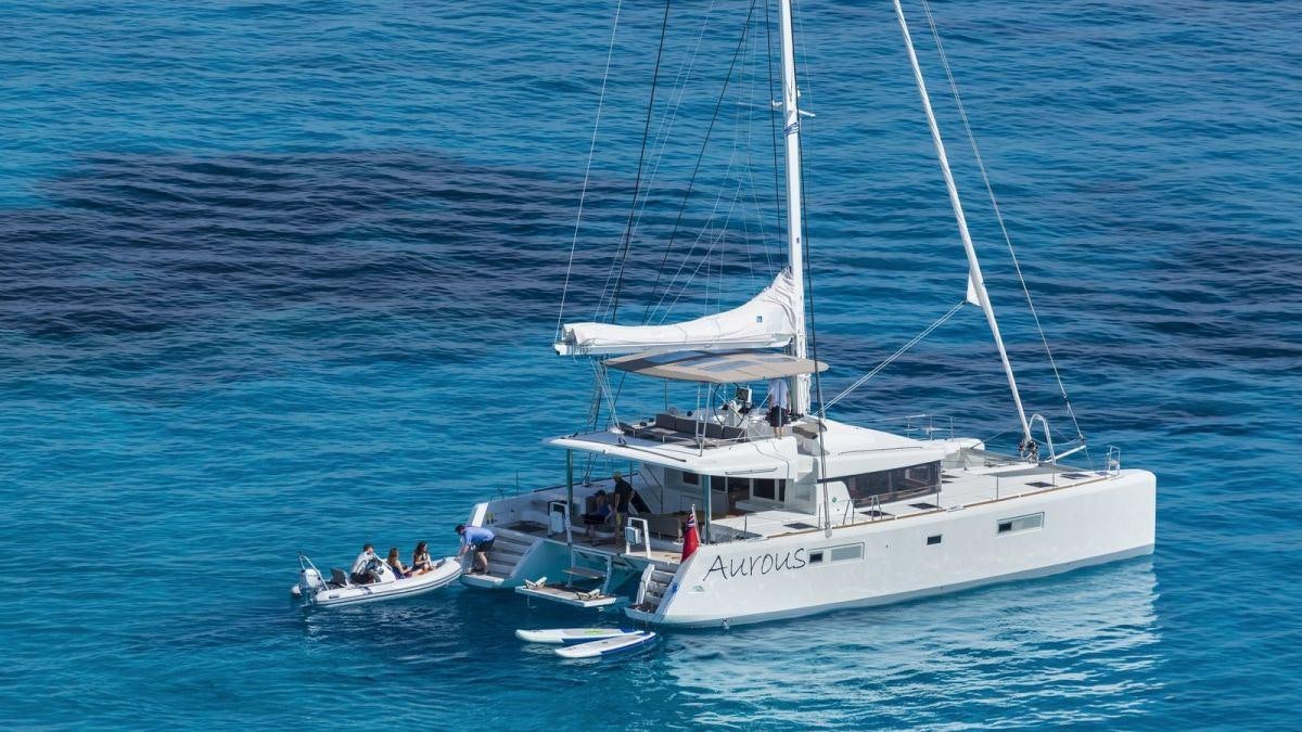 a boat with a group of people on it aboard LAGOON 52 Yacht for Charter