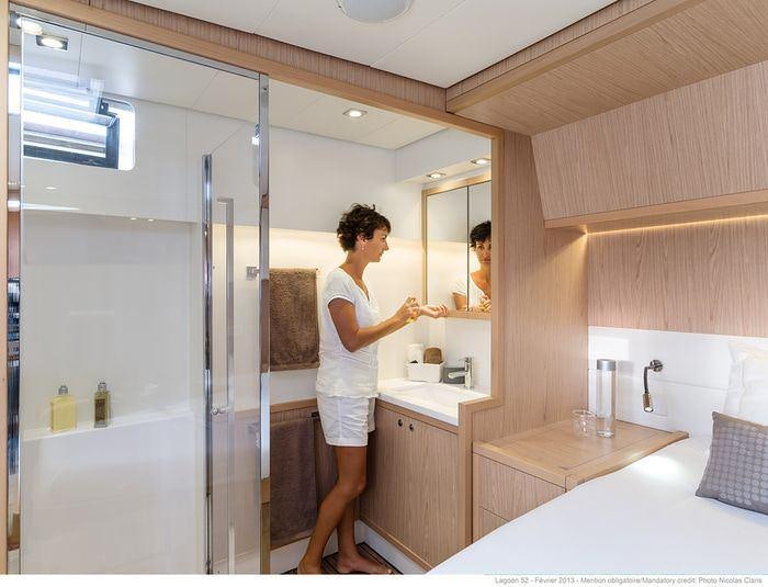 a man standing in a bathroom aboard LAGOON 52 Yacht for Charter