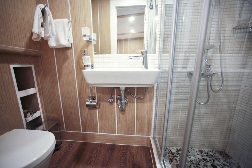 a bathroom with a sink and a shower aboard OGUZBEY Yacht for Charter