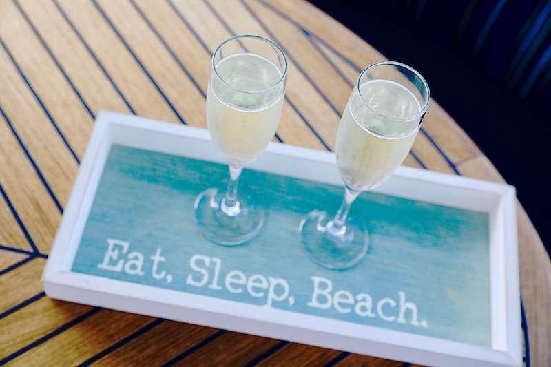 a couple of glasses of champagne on a table aboard DELPHINE Yacht for Charter