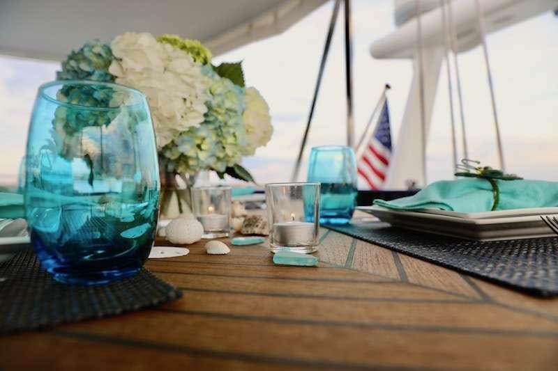 a table with vases and flowers aboard DELPHINE Yacht for Charter