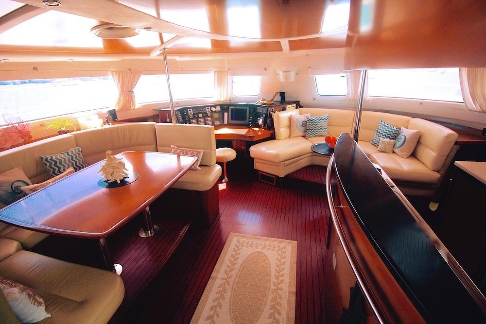 a living room with a table and chairs aboard DELPHINE Yacht for Charter