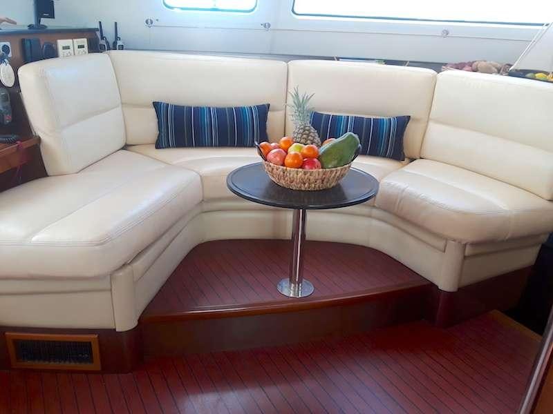 a bowl of fruit on a table aboard DELPHINE Yacht for Charter