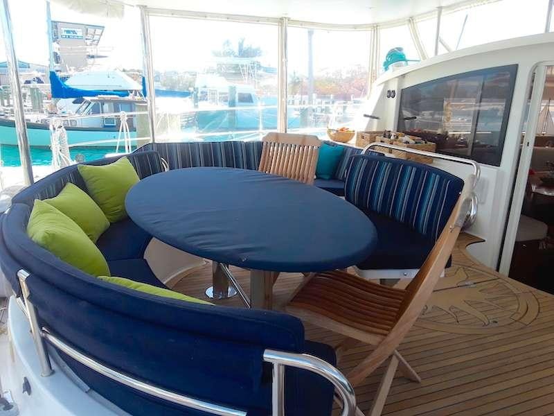 a boat with a table and chairs aboard DELPHINE Yacht for Charter