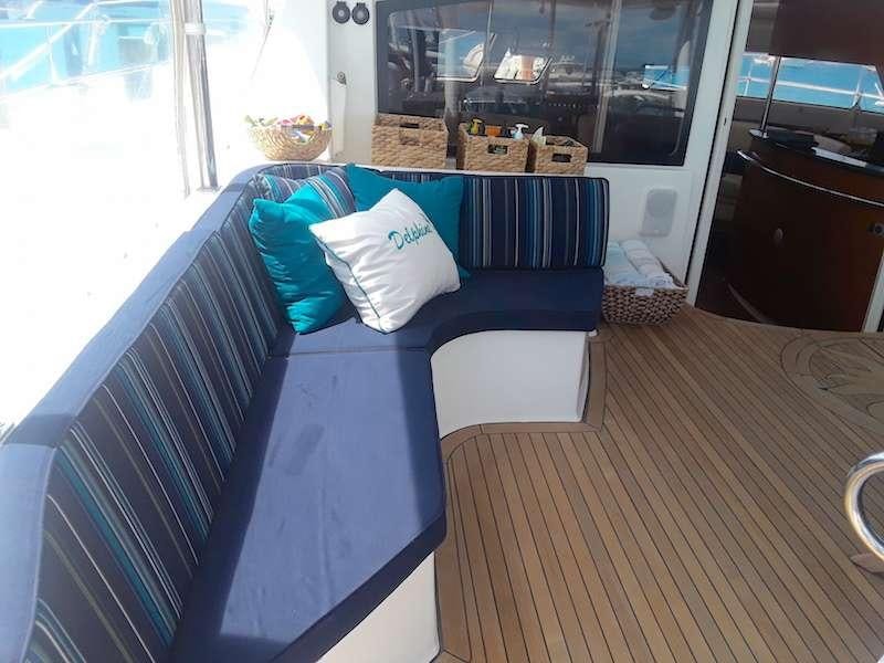 a blue couch on a porch aboard DELPHINE Yacht for Charter