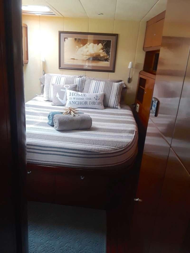 a bed with white sheets aboard DELPHINE Yacht for Charter