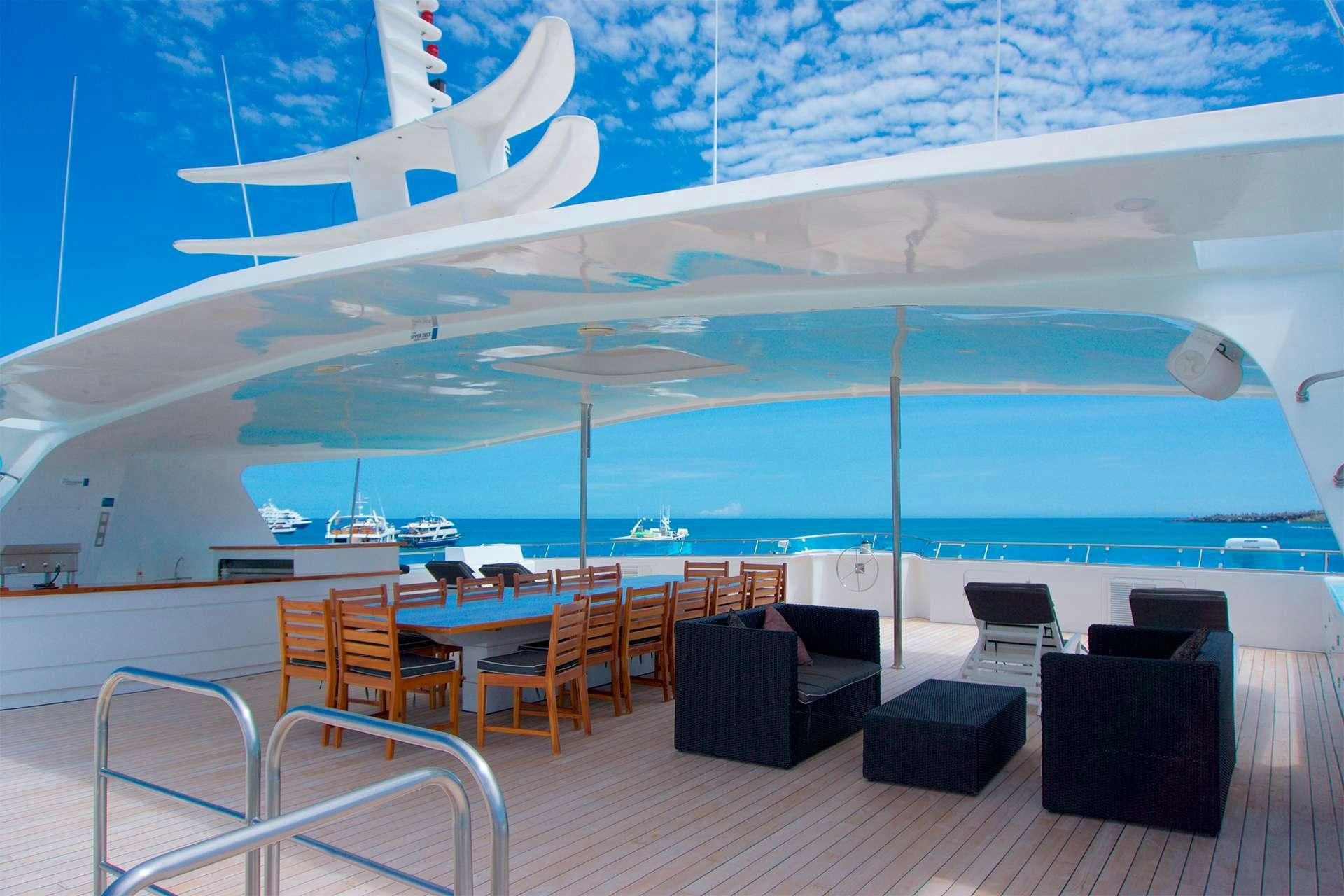 a large room with chairs and tables aboard CORMORANT Yacht for Charter