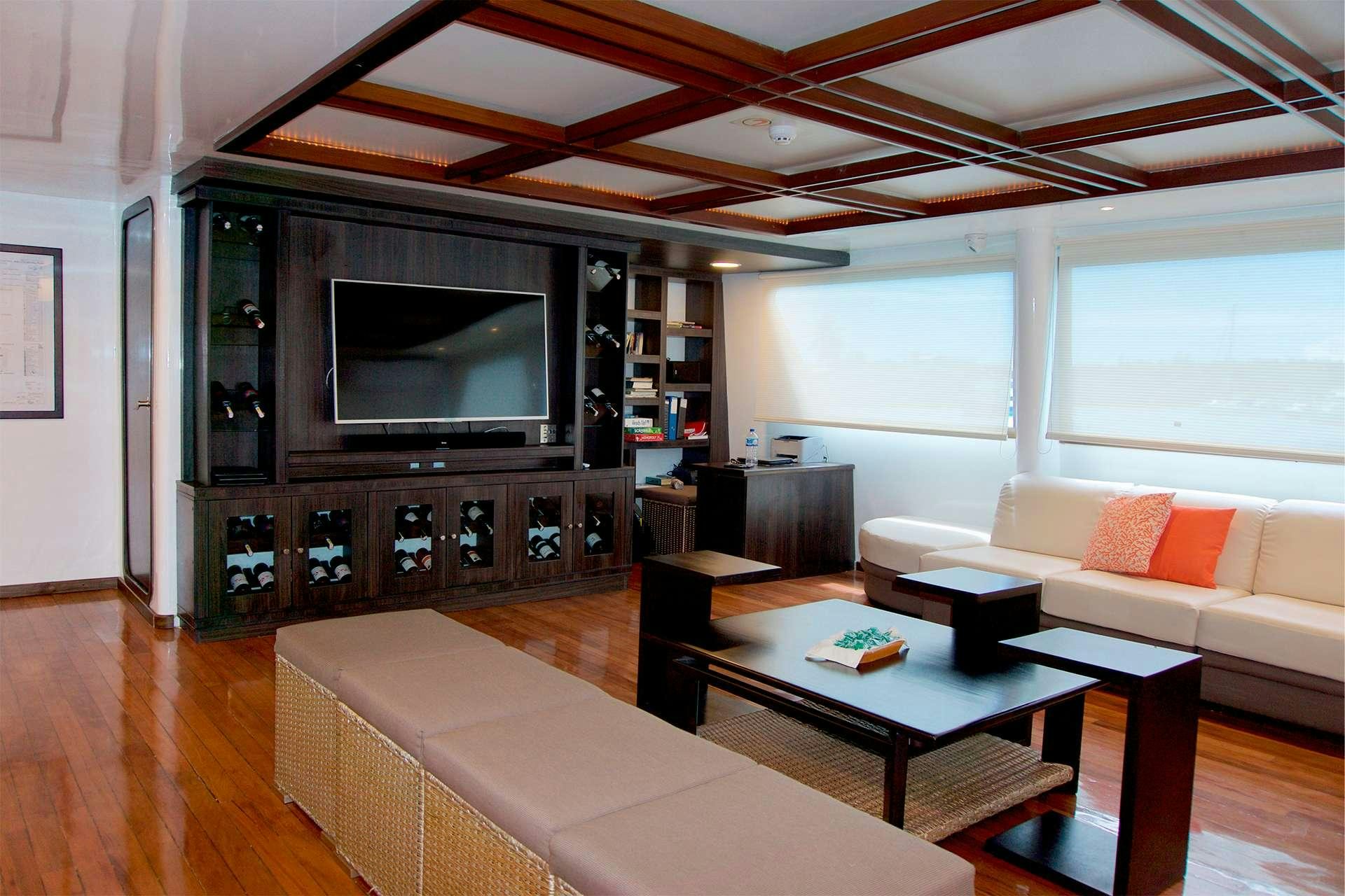 a living room with a large tv aboard CORMORANT Yacht for Charter