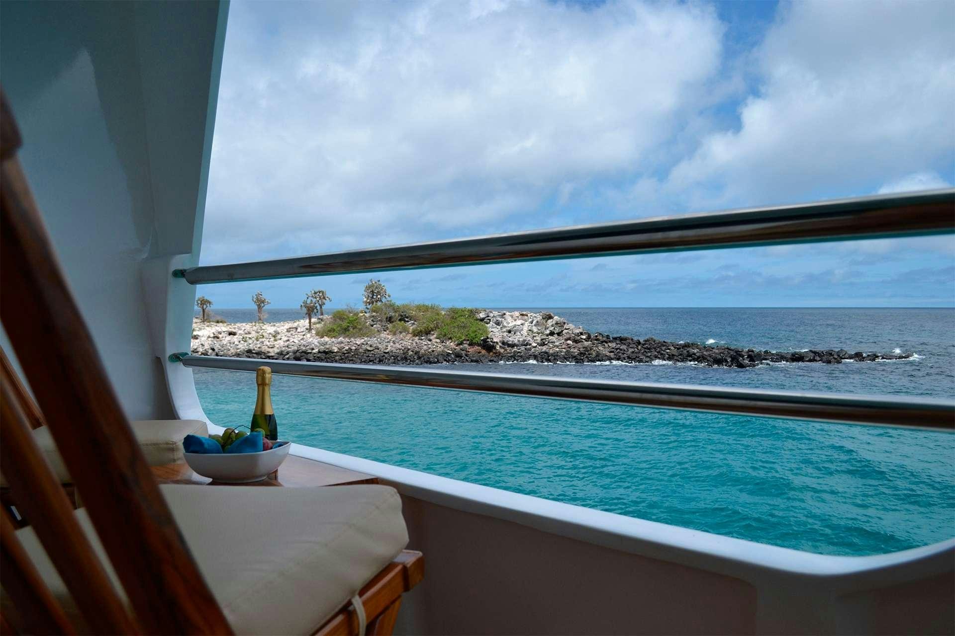 a view of a beach from a window aboard CORMORANT Yacht for Charter