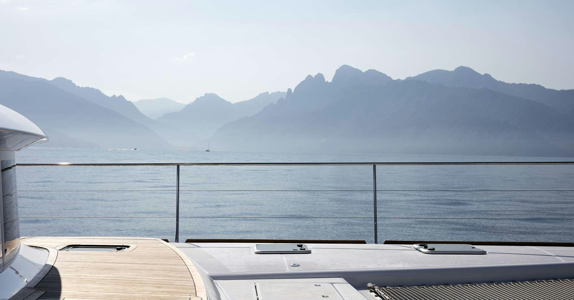 a view of a mountain from a deck of a boat aboard TWIN Yacht for Charter