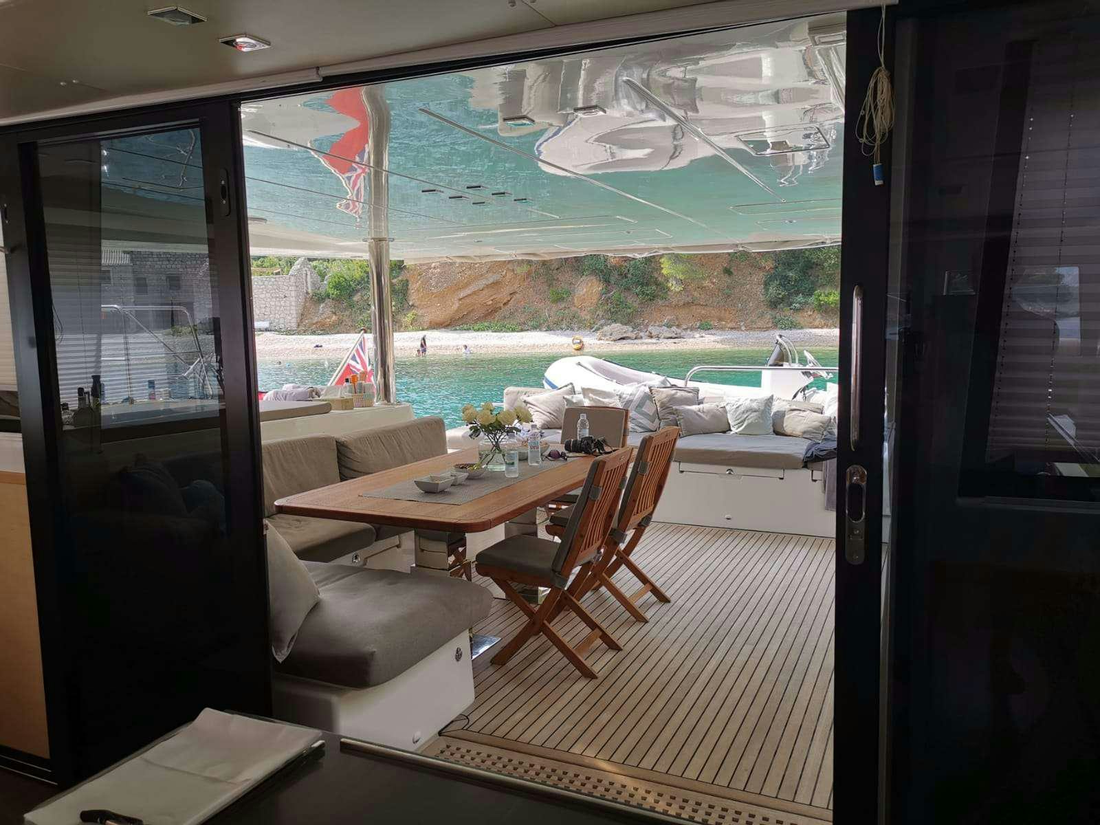 a room with a table and chairs aboard TWIN Yacht for Charter