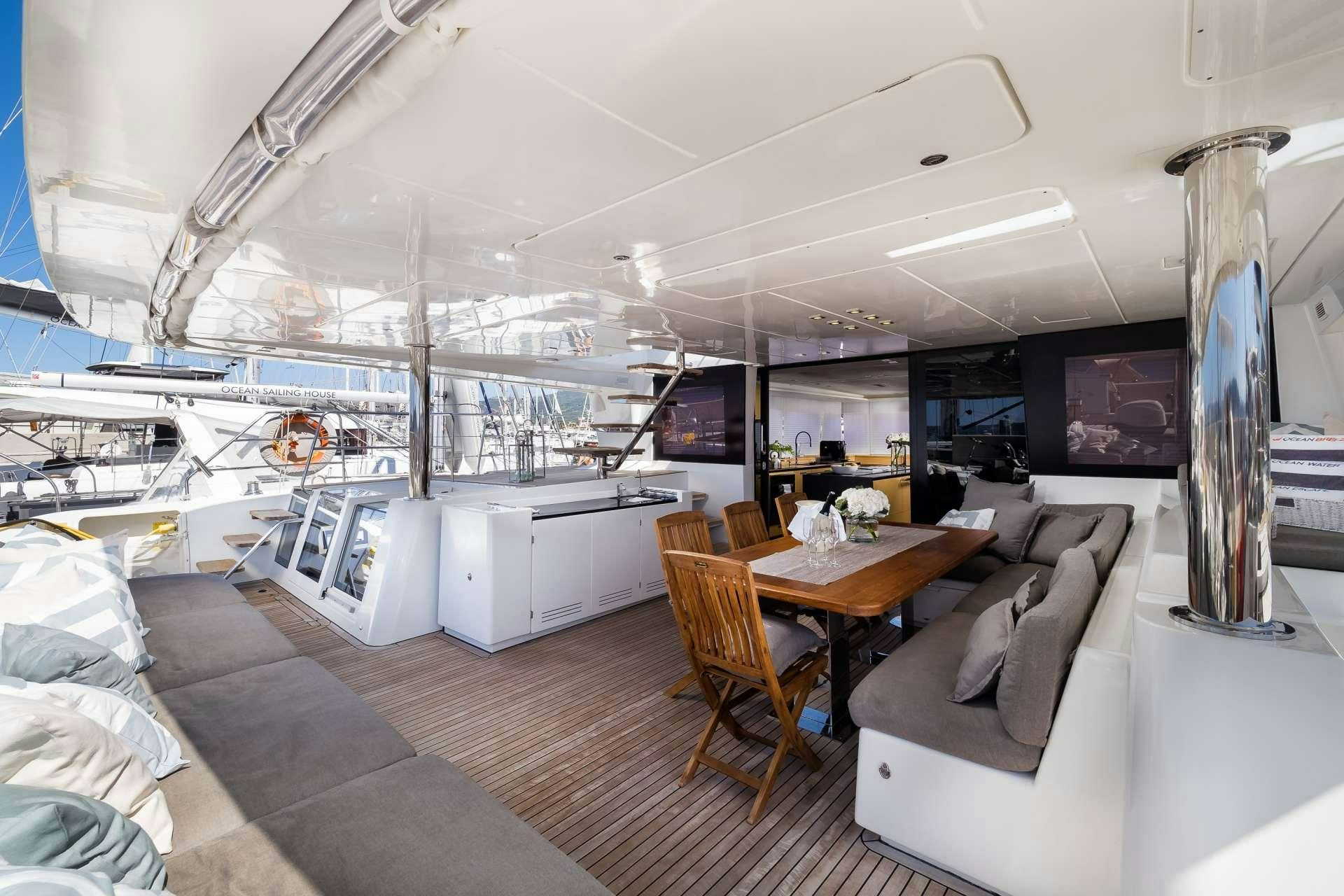 a room with a table and chairs aboard TWIN Yacht for Charter