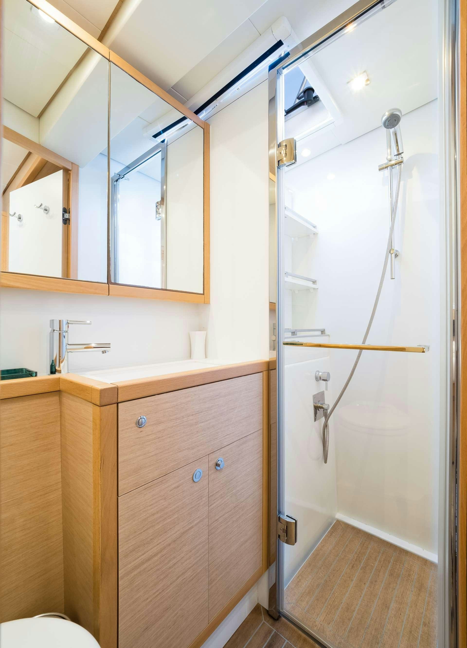 a bathroom with a shower unit aboard TWIN Yacht for Charter