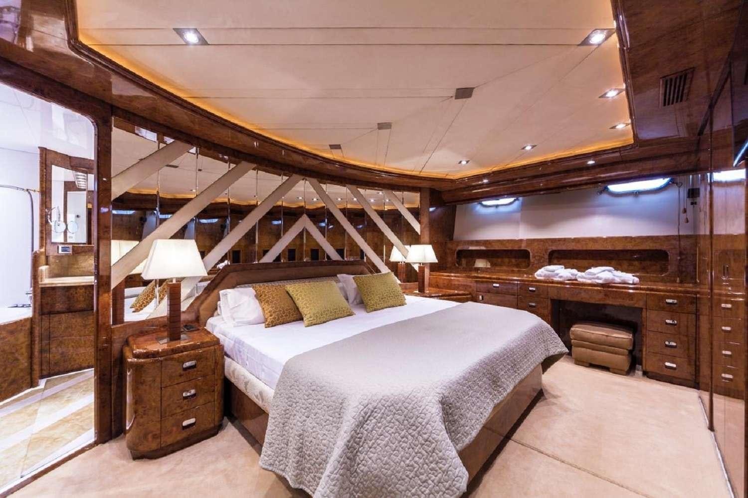 a bedroom with a large bed aboard PAULA III Yacht for Charter
