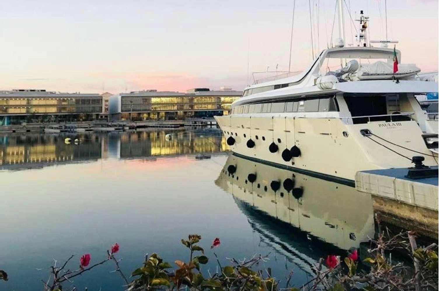 a boat docked at a pier aboard PAULA III Yacht for Charter