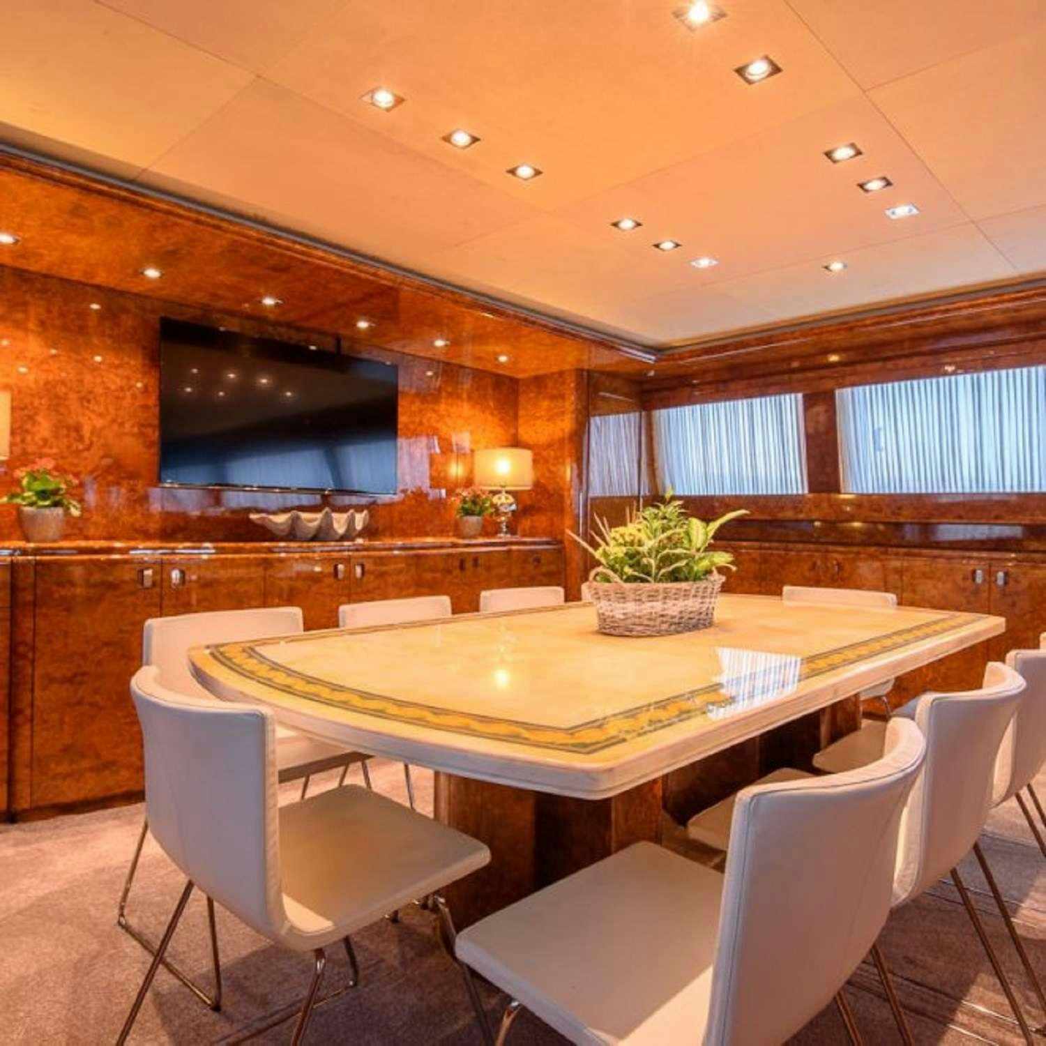 a room with a table and chairs aboard PAULA III Yacht for Charter