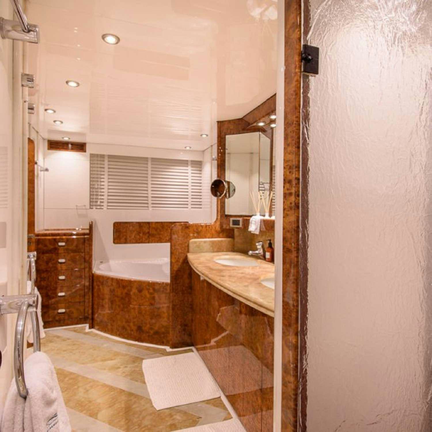 a bathroom with a tub sink and mirror aboard PAULA III Yacht for Charter