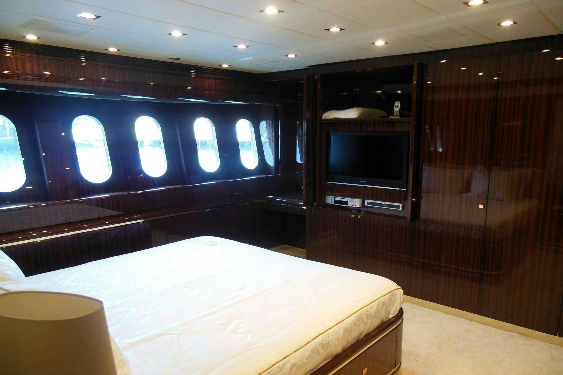 a room with a bed and tv aboard WHITE PEARL Yacht for Charter