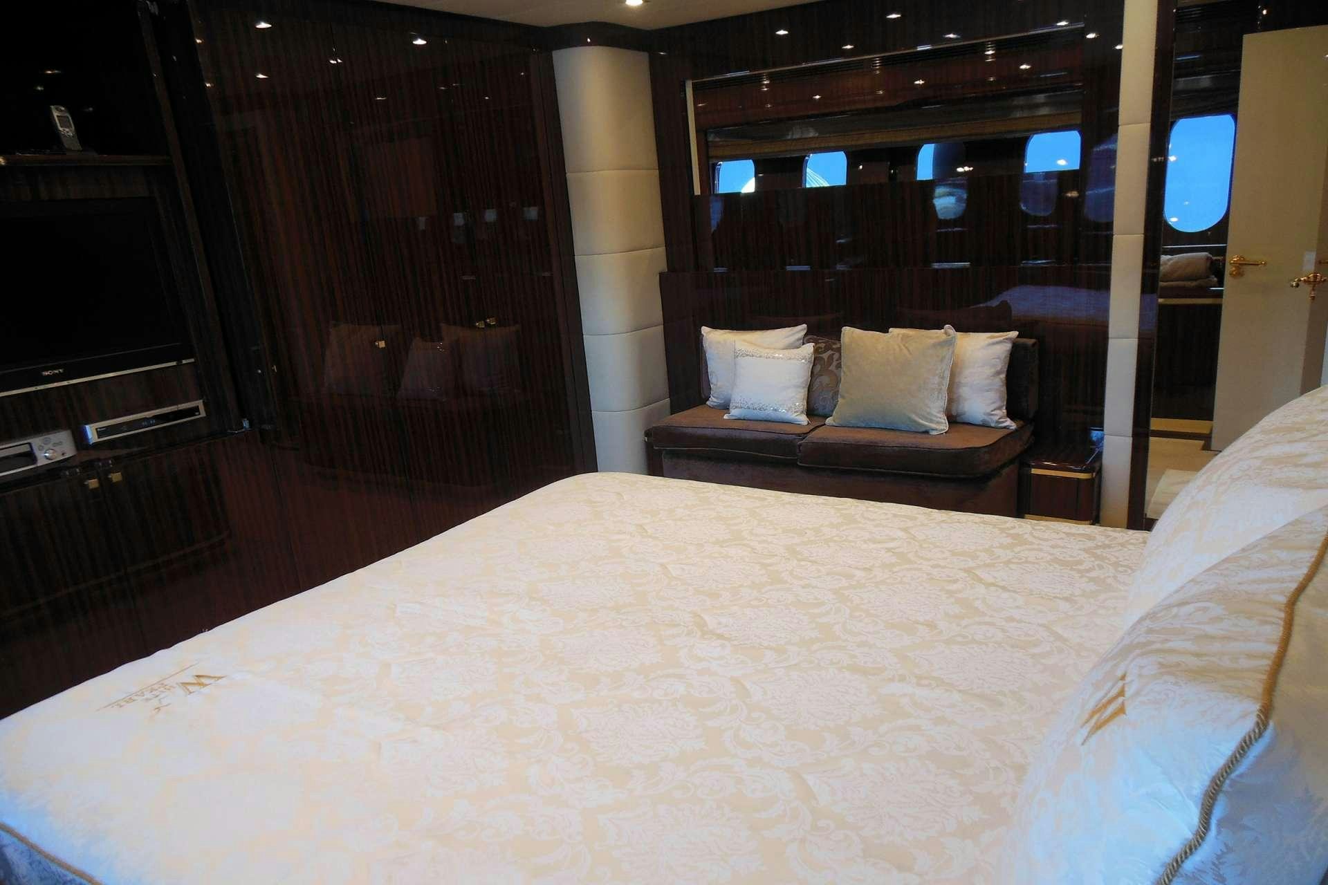 a bed with white sheets aboard WHITE PEARL Yacht for Charter